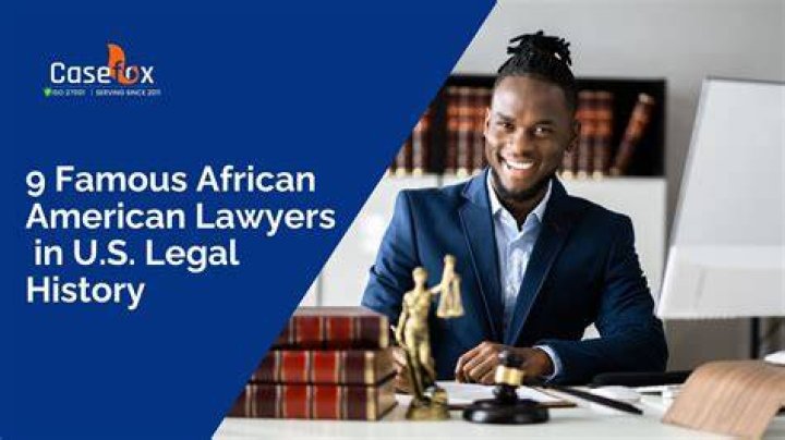 A black man in lawyers robes sits in a fancy leather chair while trying a case.
