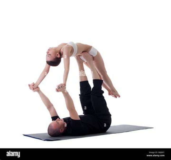 couple posing in yoga position 