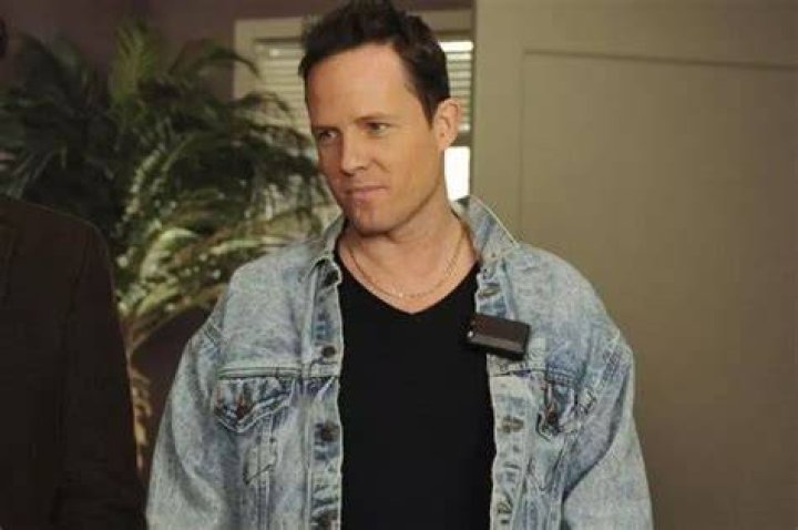 Dean Winters as Dennis Duffy, stabbing holes in a wall. 