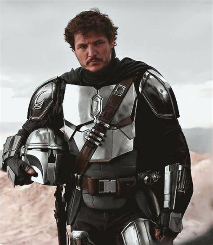 Din Djarin surveys a suit of beskar armor The Mandalorian/ Disney Plus