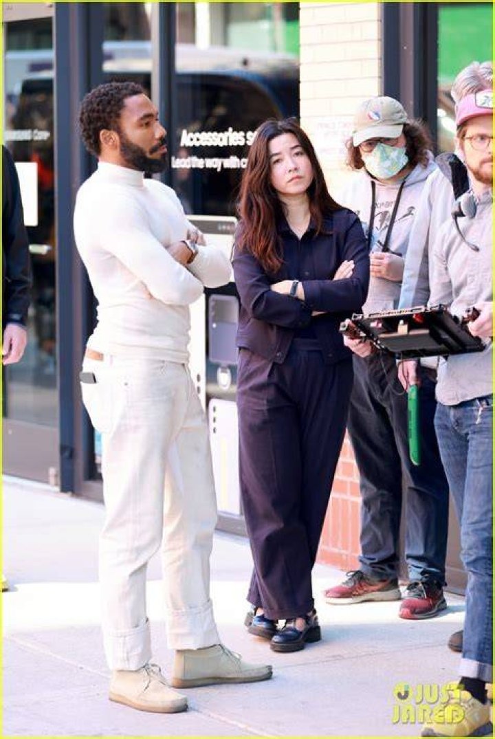Donald Glover, Maya Erskine, and Ron Perlman in Prime Video's 'Mr and Mrs. Smith'.