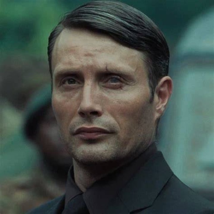 Le Chiffre torturing James Bond while both of them sweat excessively.